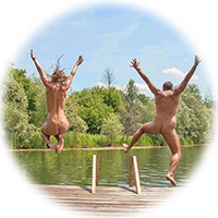 couple leaps off the end of the dock into the water