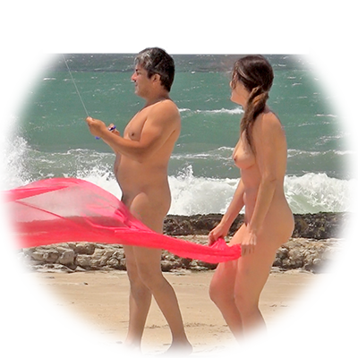Nudie group at Laguna beach flying kites