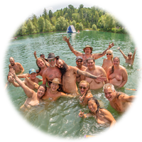 clothing-free people in the lake having fun