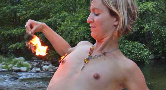 fire performer lights her own breast on fire