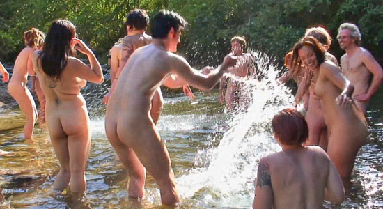nudists in the river splash each other
